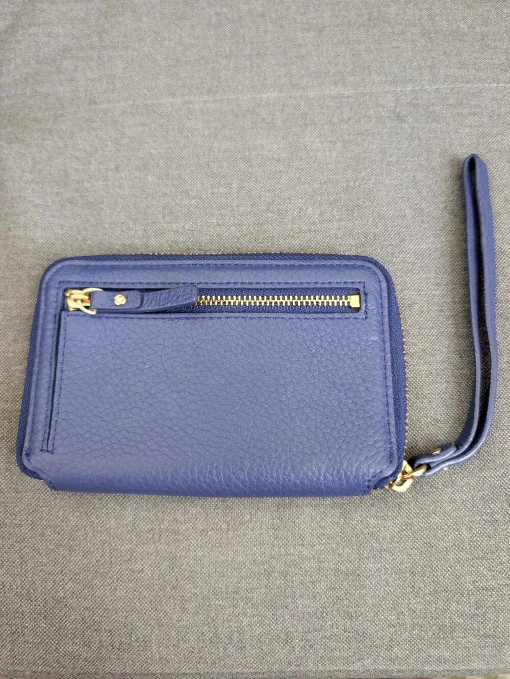 kate spade pebbled cobalt blue wristlet with gold logo